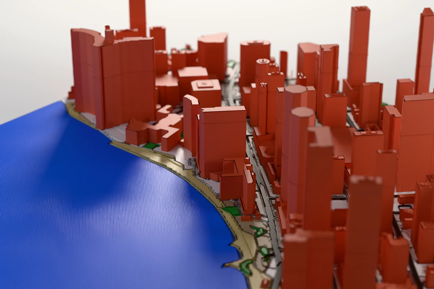 Macro detail of a printed city relief: layer lines across the water plate and the sides of individual towers.